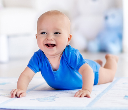 baby in onesie crawling