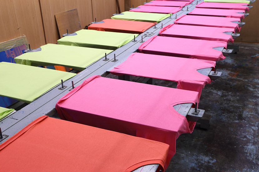 prepare colorful t-shirt on screen table