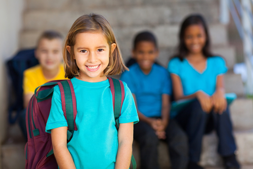 preschool girl with schoolmates in background