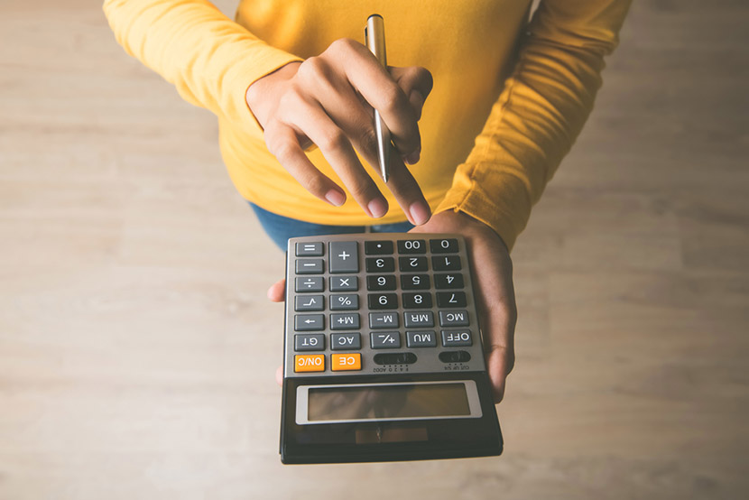 Woman entrepreneur using a calculator